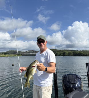 Reeling in a 16-inch Largemouth Bass under partly cloudy skies!