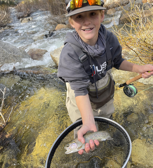 Caught a keeper in the mountain stream.