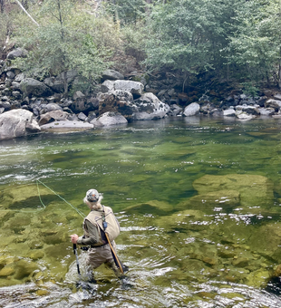 Perfect fly fishing conditions on clear water with partly cloudy skies overhead.