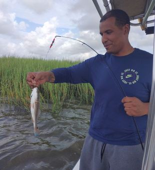 Great catch with this lively redfish on a smooth inshore day!