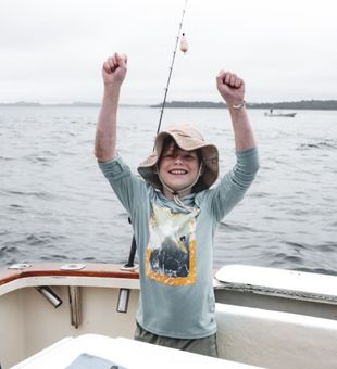 Exciting fishing success on the water – young angler celebrates the catch