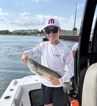 Strong striped bass moment on the water.