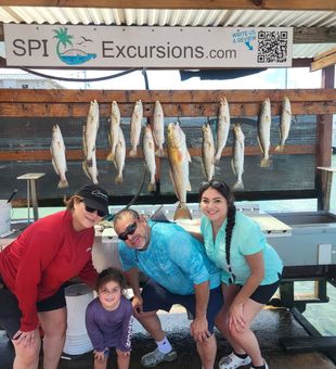 Family fishing goals: smiles, teamwork, and a cooler full of memories.