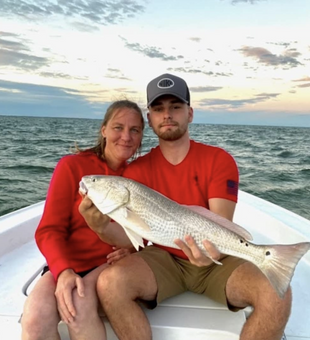 Nothing beats reeling in a beautiful redfish while sharing the moment with family. Book your fishing adventure today and experience the joy of catching fish together!
