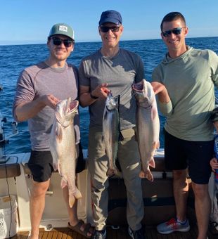 Reeling in trophy salmon on Lake Michigan with Captain Ryan.