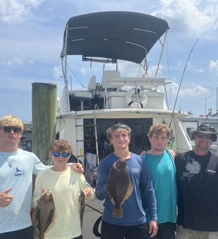 Team showing off fresh Flounder catch at the dock!