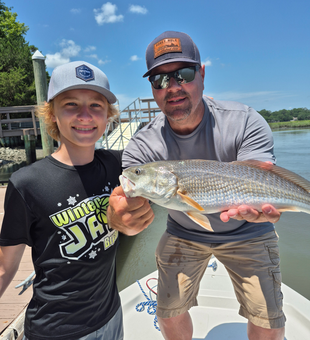 Reeling in a redfish while storm clouds brew!