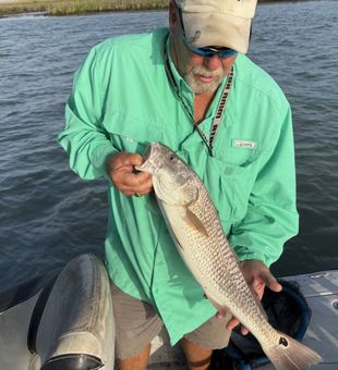 Slot red on the line in Aransas Pass. Texas flats fishing at its finest with strong runs and beautiful copper colors.