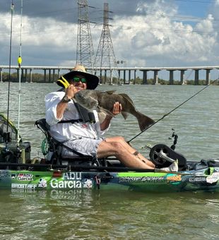 Solid black drum kayak catch on the river