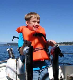 Happy young angler, fresh morning catch