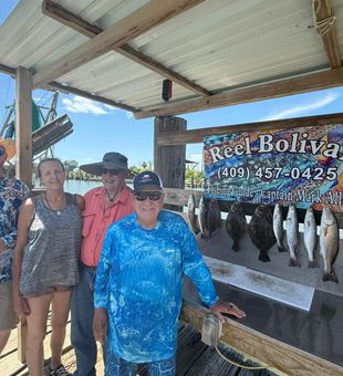 Happy anglers with a solid Flounder & Speckled Trout catch in Bolivar!