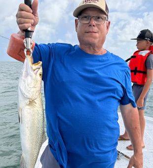 Proud catch of a hefty South Padre Island speckled trout.
