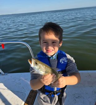 Proud young angler with a shiny Speckled Trout