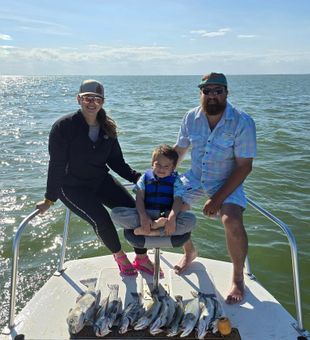 Joyful family haul of Speckled Trout