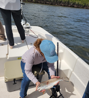 Peaceful day on the water, reeling in a catch.