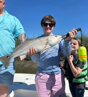 Proud Mom, a big redfish for them today! -  Midway, GA.