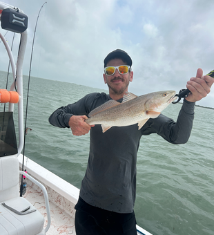 Landed a feisty redfish on a day with cloudy skies!
