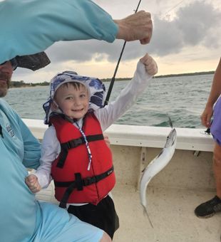 Happy kid with a Spanish Mackerel catch