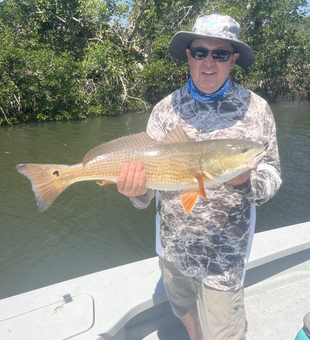 Reeling in a big redfish on a clear day in Sarasota!