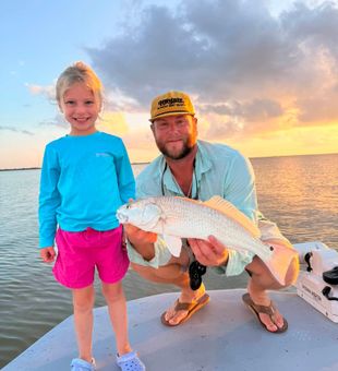Proud Redfish Catch at Sunset