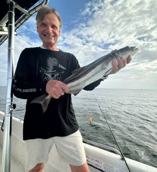 Happy — sleek Cobia catch!