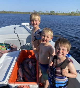 Kids with big catfish catch.