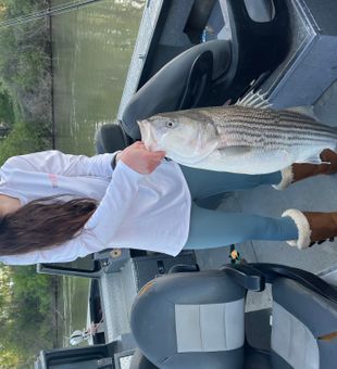 Beaming with a hefty Striped Bass!