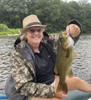 Smiling with a beautiful Smallmouth Bass catch on the river!