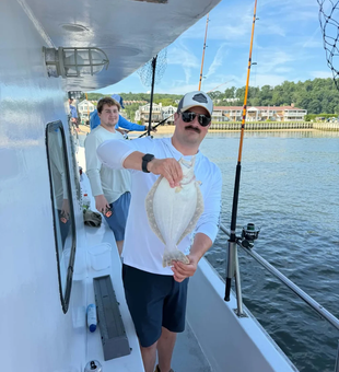 Smiling angler with an Atlantic Highlands Flounder.