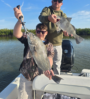 Reeling 'em in by the lake.