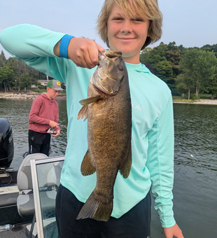 Big 65-inch Smallmouth Bass caught in Sturgeon Bay's partly cloudy waters!
