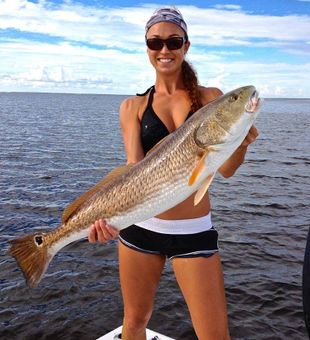 Impressive redfish catch with smiling angler.