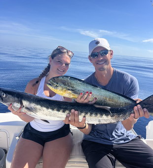 Reeling in a big Mahi Mahi as the skies clear!