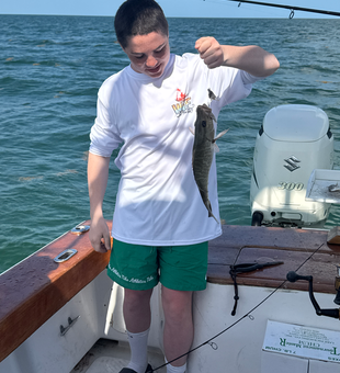 Enjoying a day by the water with a catch of the day.