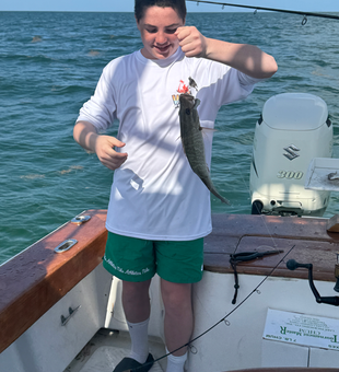 Reeling in a great catch on a peaceful day by the water.