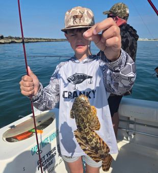 Young angler with Grouper catch on Murrells Inlet fishing charter
