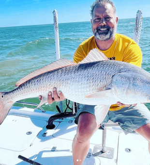 Inshore fishing in Gulf Breeze, FL targeting redfish and speckled trout in calm coastal waters.