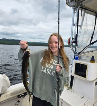 Joyful angler with a sleek lake trout!