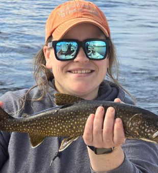 Happy angler with a lively brook trout catch!