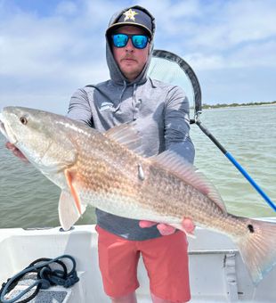 Nothing like landing a solid redfish out on the water.
