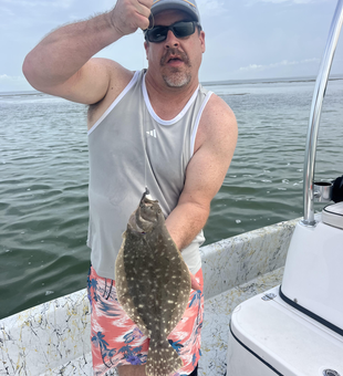 Flounder finesse: Deep sea success in Port Mansfield's clear skies!