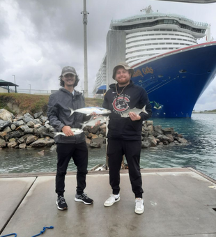 A proud guest holding a freshly caught fish during a Port Canaveral charter fishing trip, one of the day’s highlights