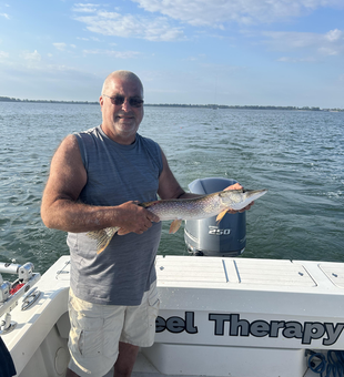 Jigging success: Northern Pike on the line in partly cloudy Oregon!
