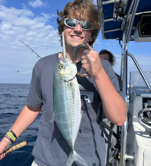 Reeling in a Blue Runner on a partly cloudy day with storms brewing!