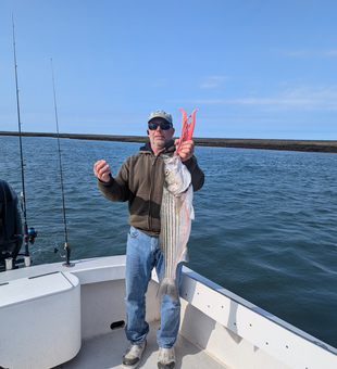Reeling in a big striped bass off the Atlantic City coast!