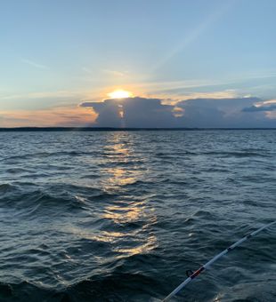 Sunset serenity meets striped bass excitement!