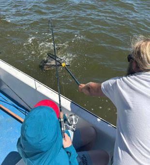 Kids enjoying their first fishing trip with Captai