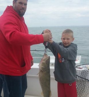 kid reels in Walleye in Lake Erie Fishing Charters