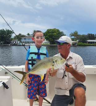 Angler landing a fish on a Bradenton flats fishing charter