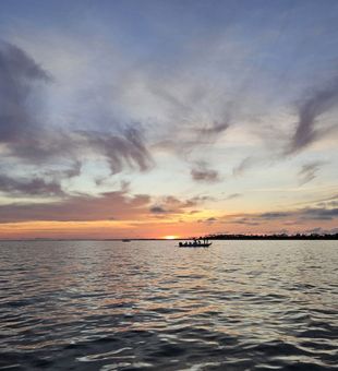 Vibrant Gulf Coast sunset over calm fishing waters